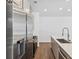 Modern kitchen with stainless steel appliances and wood floors at 2036 S Holly St # 4, Denver, CO 80222