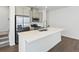 Kitchen featuring an island with white countertop and stainless steel appliances at 2036 S Holly St # 4, Denver, CO 80222