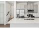 Modern kitchen with white cabinets, stainless appliances, spring faucet, quartz countertops and plenty of storage at 2036 S Holly St # 4, Denver, CO 80222