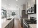 Modern kitchen boasts stainless appliances, a kitchen island with quartz countertops, and lots of natural light at 2036 S Holly St # 4, Denver, CO 80222
