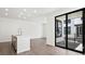 Bright, open-concept living room with a kitchen island and large sliding glass doors to the patio at 2036 S Holly St # 4, Denver, CO 80222