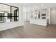 Open-concept living space with wood floors, kitchen and modern windows at 2036 S Holly St # 4, Denver, CO 80222