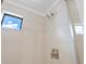 Tiled shower stall featuring a window, modern fixtures, and clean, neutral finishes at 2036 S Holly St # 4, Denver, CO 80222