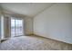 Bedroom with neutral carpet and slider door accessing the balcony at 2875 Blue Sky Cir # 4-303, Erie, CO 80516