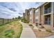 Well-maintained condo exterior with stone accents, private balcony, and manicured landscaping at 2875 Blue Sky Cir # 4-303, Erie, CO 80516