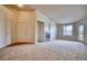 Bright living room features a fireplace, neutral carpeting, and access to the outside at 2875 Blue Sky Cir # 4-303, Erie, CO 80516