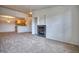 Cozy living room with fireplace open to kitchen featuring stainless steel appliances at 2875 Blue Sky Cir # 4-303, Erie, CO 80516