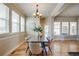 Dining room with hardwood floors, neutral walls, natural light, and modern chandelier at 8992 E 5Th Pl, Denver, CO 80230