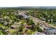 Elevated view features the house with a deck in a lush neighborhood near local retail at 2180 Myrtlewood Ln, Lakewood, CO 80215