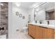 Modern bathroom featuring double sinks and decorative sconces at 2180 Myrtlewood Ln, Lakewood, CO 80215