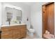 Bathroom featuring double sink vanity and a modern tiled shower at 2180 Myrtlewood Ln, Lakewood, CO 80215