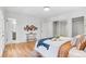 Well-lit bedroom featuring hardwood floors and double door closet at 2180 Myrtlewood Ln, Lakewood, CO 80215