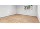 This bright room has light wood floors, a window, and white walls at 2180 Myrtlewood Ln, Lakewood, CO 80215