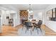 Dining room featuring a round table, modern decor, and an adjacent kitchen at 2180 Myrtlewood Ln, Lakewood, CO 80215