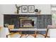 Close up of living room fireplace with black brick, decor, and furniture in view at 2180 Myrtlewood Ln, Lakewood, CO 80215