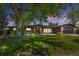 Charming home with a large tree, lush green lawn, and inviting red front door at 2180 Myrtlewood Ln, Lakewood, CO 80215