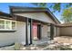 Inviting front entrance with a red door, classic columns, and decorative lighting at 2180 Myrtlewood Ln, Lakewood, CO 80215