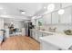 Kitchen featuring white cabinets, stainless steel appliances, and an adjacent dining area at 2180 Myrtlewood Ln, Lakewood, CO 80215