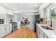 Bright updated kitchen with stainless steel appliances and an adjacent dining area at 2180 Myrtlewood Ln, Lakewood, CO 80215
