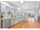 Bright updated kitchen featuring white cabinets and stainless steel appliances at 2180 Myrtlewood Ln, Lakewood, CO 80215