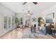 Bright living room with hardwood floors, ceiling fan and grey sofa at 2180 Myrtlewood Ln, Lakewood, CO 80215