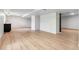 Living room with light wood floors, white walls, and bar with cabinets at 2180 Myrtlewood Ln, Lakewood, CO 80215