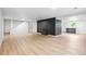 This modern living room features light wood floors, a black brick fireplace, and wet bar with cabinets at 2180 Myrtlewood Ln, Lakewood, CO 80215