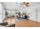 Bright living room with hardwood floors, ceiling fans and plantation shutters at 2180 Myrtlewood Ln, Lakewood, CO 80215