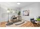 Bright home office with hardwood floors, modern rug and a window at 2180 Myrtlewood Ln, Lakewood, CO 80215