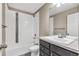 Clean bathroom with combined shower and tub with white tiles and a vanity with a mirror at 1677 Valley Oak Ct, Castle Rock, CO 80104