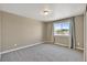 Cozy bedroom with neutral walls, carpet, and a window offering an exterior view at 1677 Valley Oak Ct, Castle Rock, CO 80104