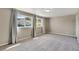 Spacious bedroom featuring plush carpeting, neutral paint, and views of the neighborhood through large windows at 1677 Valley Oak Ct, Castle Rock, CO 80104