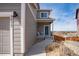 Charming home with a quaint front porch featuring seating and a welcoming blue front door with wreath at 1677 Valley Oak Ct, Castle Rock, CO 80104