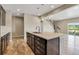 Modern kitchen featuring an island, dark cabinets, pendant lighting, and stainless steel appliances at 1677 Valley Oak Ct, Castle Rock, CO 80104