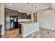 Bright kitchen featuring dark cabinets, stainless appliances, a center island with stylish pendant lights at 1677 Valley Oak Ct, Castle Rock, CO 80104