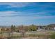 Scenic view of rolling hills, a grassy field, and the neighborhood with a bright blue sky above at 1677 Valley Oak Ct, Castle Rock, CO 80104
