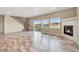 Bright and open living room featuring a fireplace, large windows, and a sliding glass door to the patio at 1677 Valley Oak Ct, Castle Rock, CO 80104
