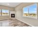Cozy living room showcasing a corner fireplace, hardwood floors, and large windows with scenic views at 1677 Valley Oak Ct, Castle Rock, CO 80104