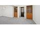 Finished basement featuring built-in shelving and ample storage space behind double doors at 9338 W Utah Pl, Lakewood, CO 80232