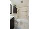 Cozy bathroom featuring tiled walls, tiled floor and a shower over the tub at 9338 W Utah Pl, Lakewood, CO 80232
