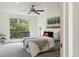 A bright bedroom with a large window, ceiling fan, and neutral decor at 9338 W Utah Pl, Lakewood, CO 80232