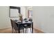 The dining room includes a modern light fixture, hardwood floors, and neutral decor at 9338 W Utah Pl, Lakewood, CO 80232