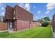 Inviting townhome featuring brick accents, a well-maintained lawn, and a private entrance at 9338 W Utah Pl, Lakewood, CO 80232