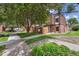 Well-maintained townhomes surrounded by mature trees and manicured landscaping at 9338 W Utah Pl, Lakewood, CO 80232