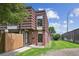 Charming townhome with brick accents, a well-manicured lawn, and a private fenced yard at 9338 W Utah Pl, Lakewood, CO 80232