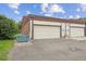 Attached garages with white doors and plenty of parking space at 9338 W Utah Pl, Lakewood, CO 80232