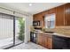 The kitchen features a sliding glass door, tiled flooring and back splash, and black appliances at 9338 W Utah Pl, Lakewood, CO 80232