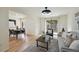 The living room features hardwood floors, neutral decor, and is open to the dining area at 9338 W Utah Pl, Lakewood, CO 80232