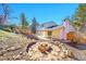 Spacious backyard with a stone fire pit and covered patio at 3798 S Wabash St, Denver, CO 80237