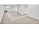 Open finished basement area featuring neutral carpet and freshly painted white walls at 3798 S Wabash St, Denver, CO 80237